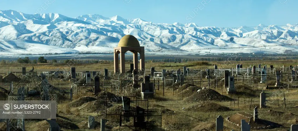 Kyrgyzstan, Muslim cemetery with Tian Shan Mountains in background