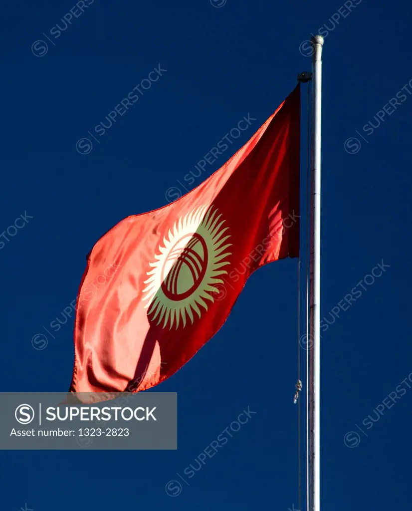 Flag of Kyrgyzstan against blue sky