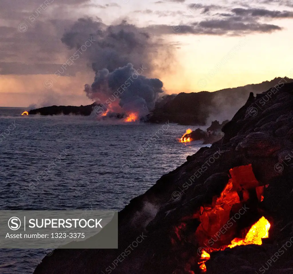 USA, Hawaii, Sunset and flowing lava in Hawaii Volcanoes National Park