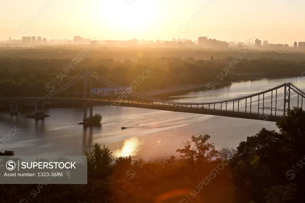 Parkovy Bridge on the Dnieper River at sunset, Kiev, Ukraine