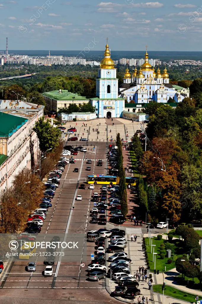Aerial view of cars parked at a parking lot with a church in the background, St. Michael's Golden-Domed Monastery, Kiev, Ukraine