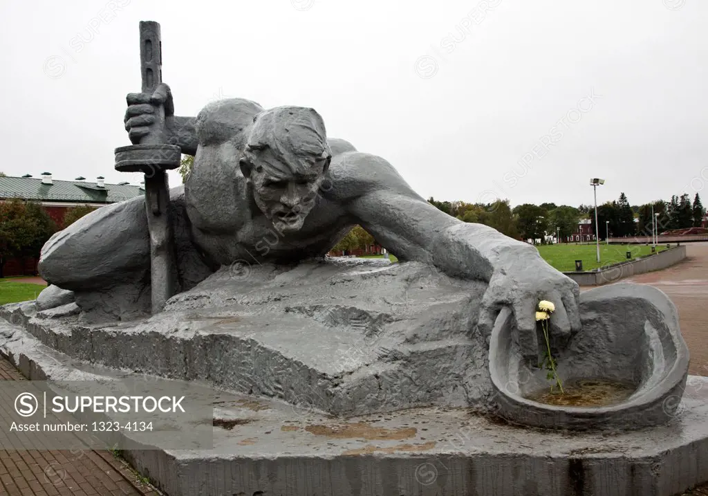 Belarus, Brest, Brest Fortress, Sculpture Thirst and barracks in background in Brest Memorial Complex