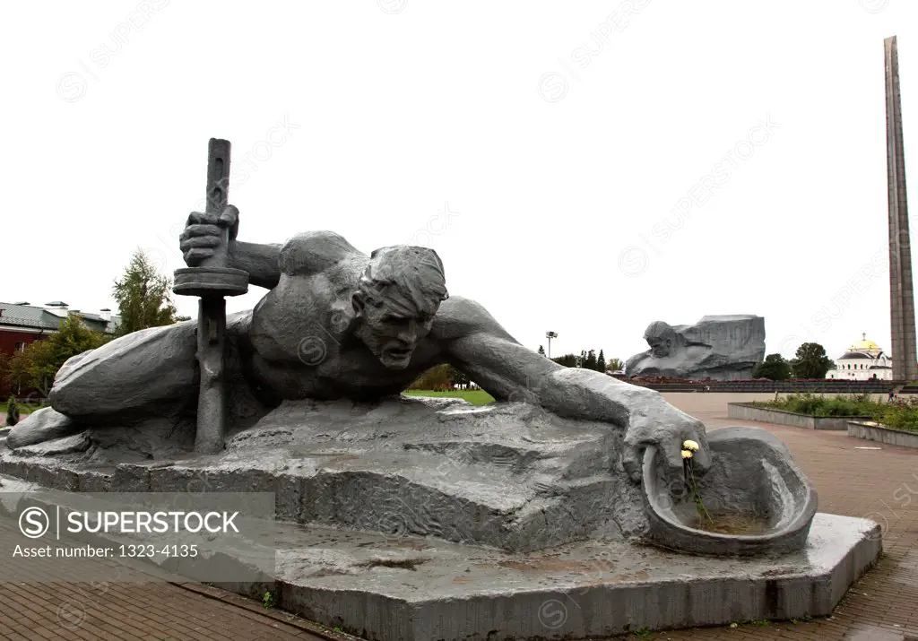 Belarus, Brest, Brest Fortress, Sculpture Thirst and barracks in background in Brest Memorial Complex