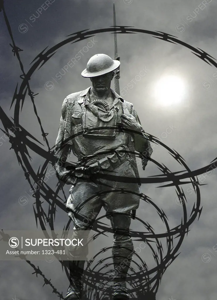 High angle view of a soldier's statue standing in barbed wire