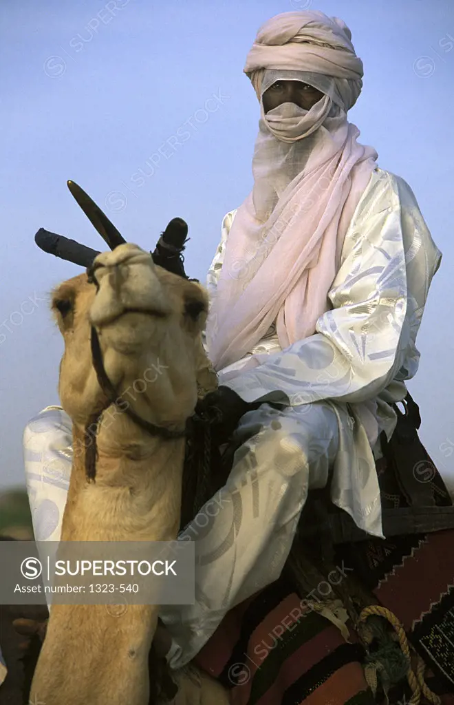 Young man riding a camel, Niger