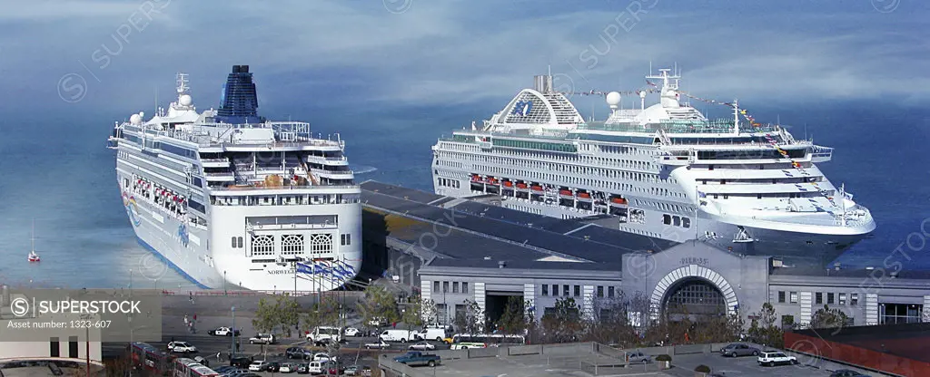 Two cruise ships docked in a harbor