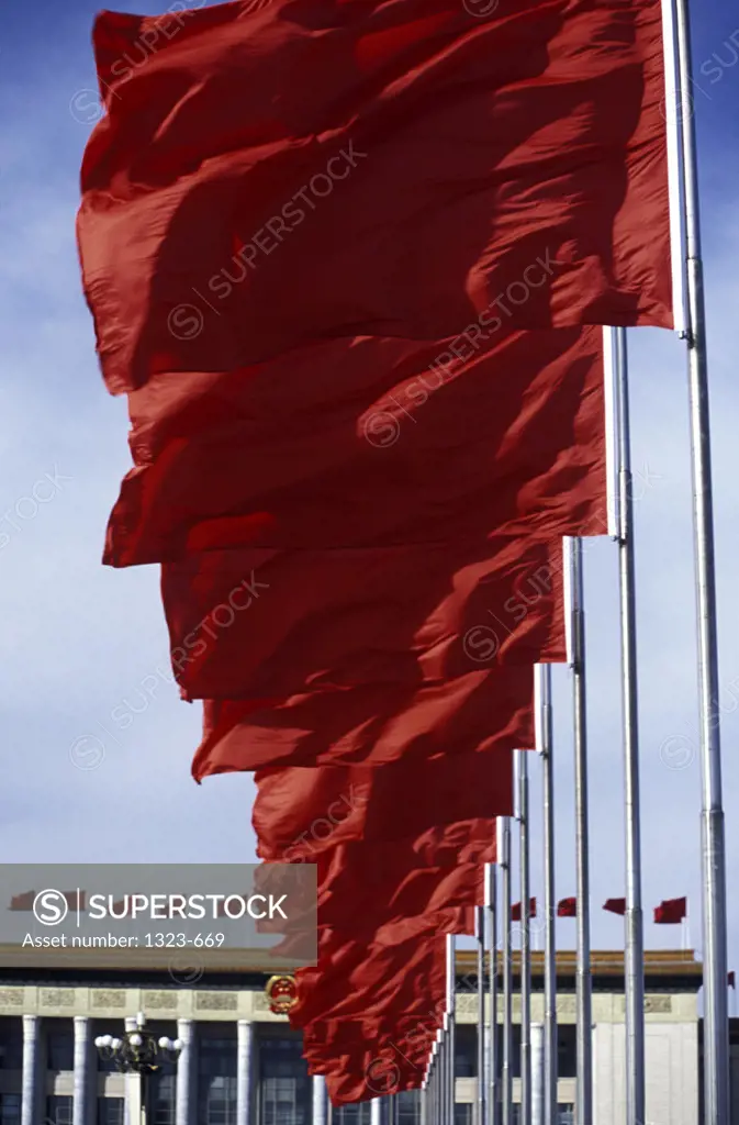 Low angle view of Chinese flags in a row in front of a palace, Tiananmen Square, Beijing, China