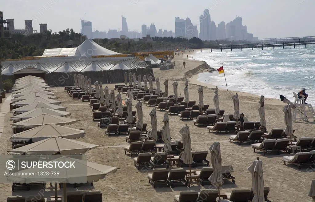 High angle view of lounge chairs and beach umbrellas at a tourist resort, Madinat Jumeirah Hotel, Dubai, United Arab Emirates