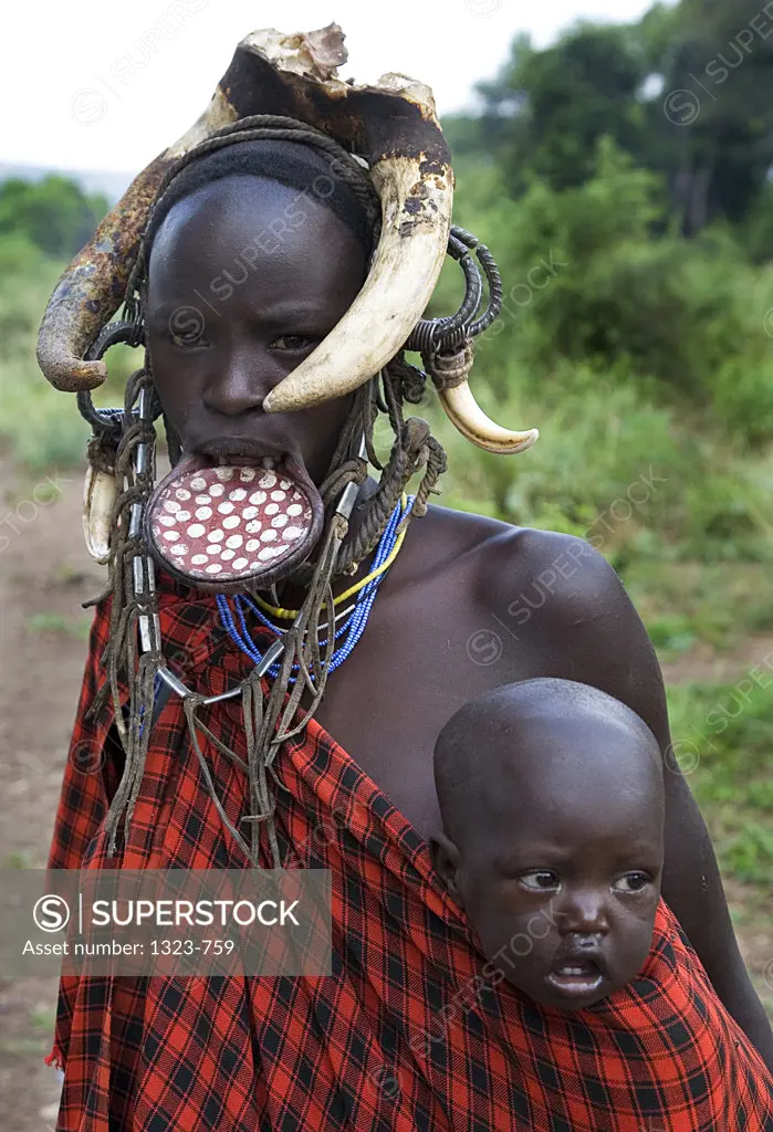 Close-up of a Mursi woman with her baby, Ethiopia