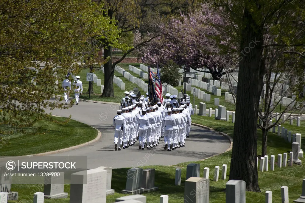 Navy soldiers marching with American flag in a cemetery, Arlington National Cemetery, Arlington, Virginia, USA