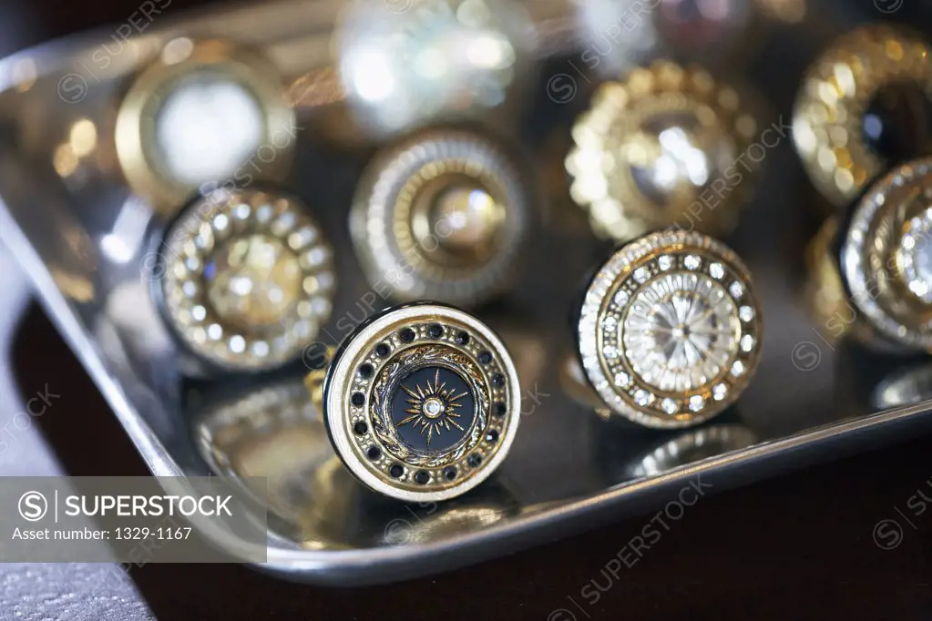 Costume jewelry rings displayed on silver platter