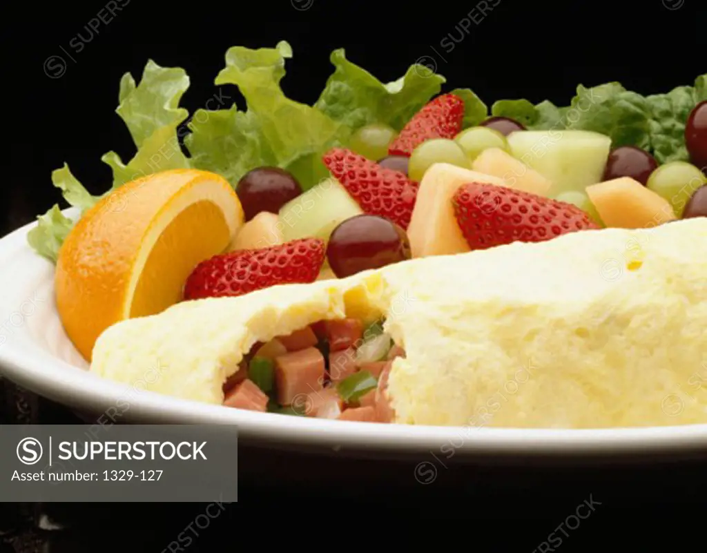 Close-up of fruit with an omelet on a plate