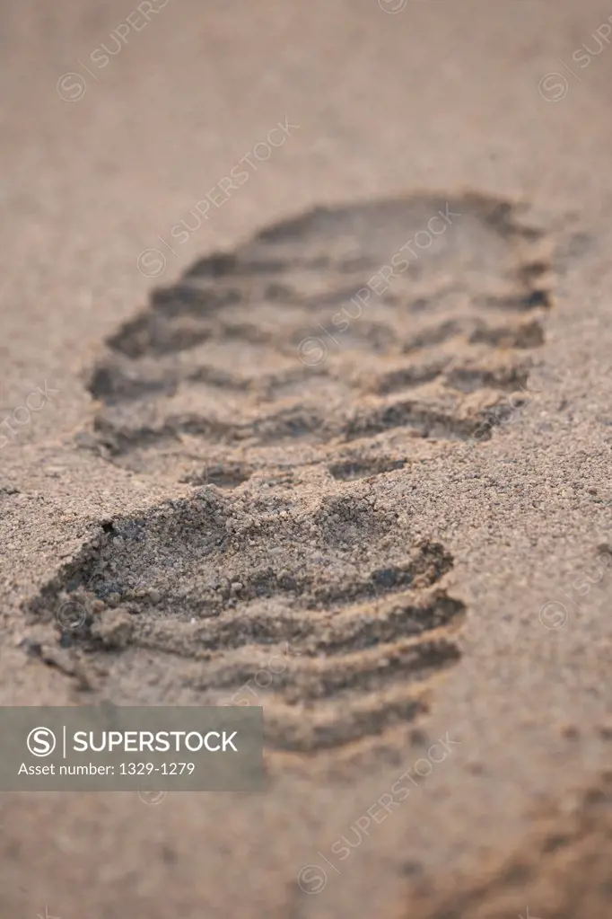 Close-up of shoe print on sand