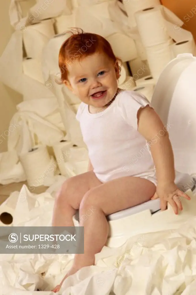 Portrait of a baby boy sitting on a potty seat