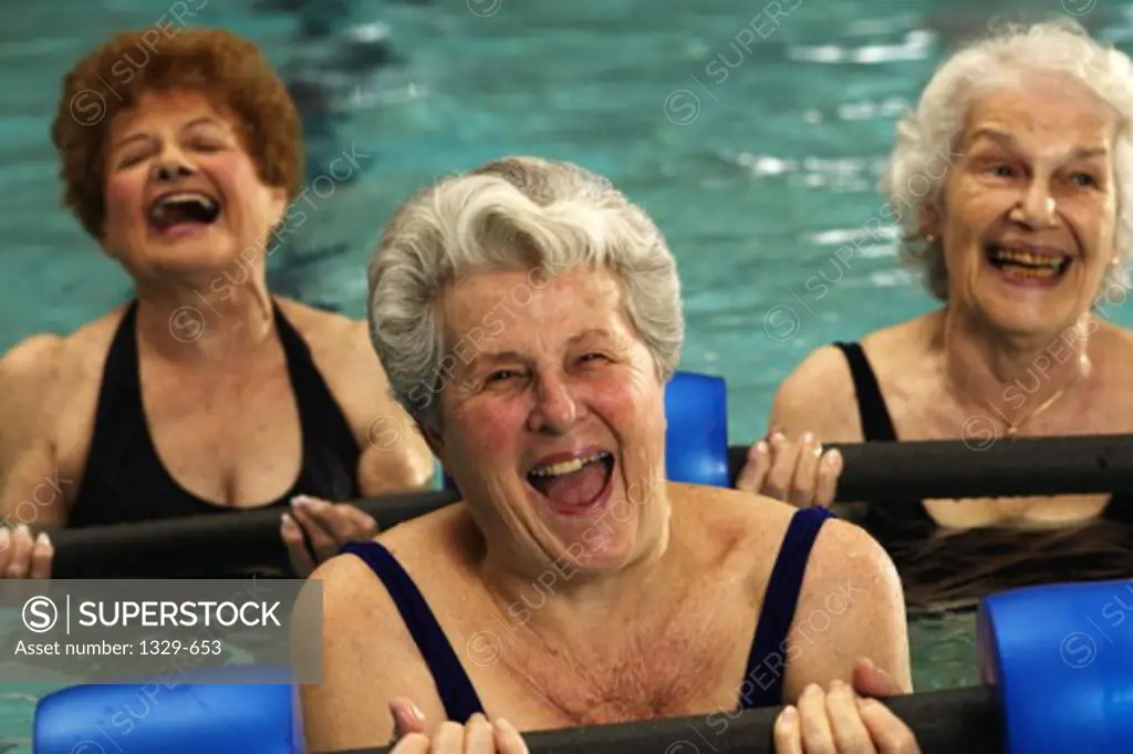 Portrait of three senior women exercising in a swimming pool