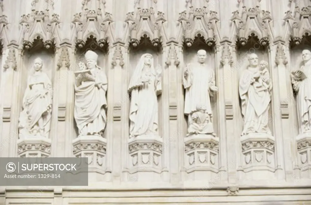 Low angle view of statues on top of an abbey, Westminster Abbey, London, England