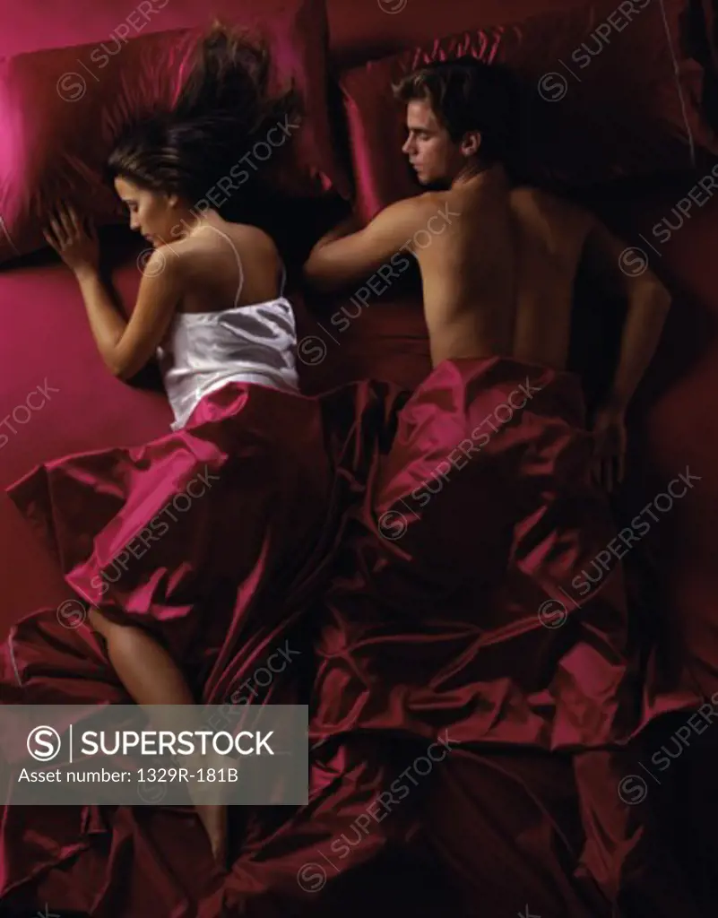 Young couple sleeping together in a bed