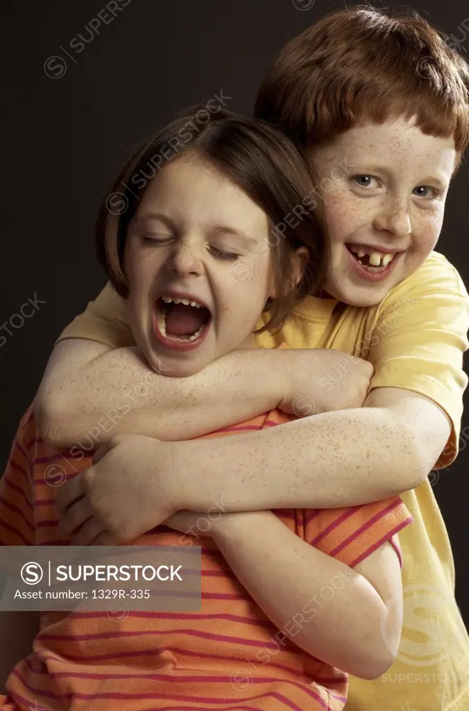 Portrait of a boy choking a girl