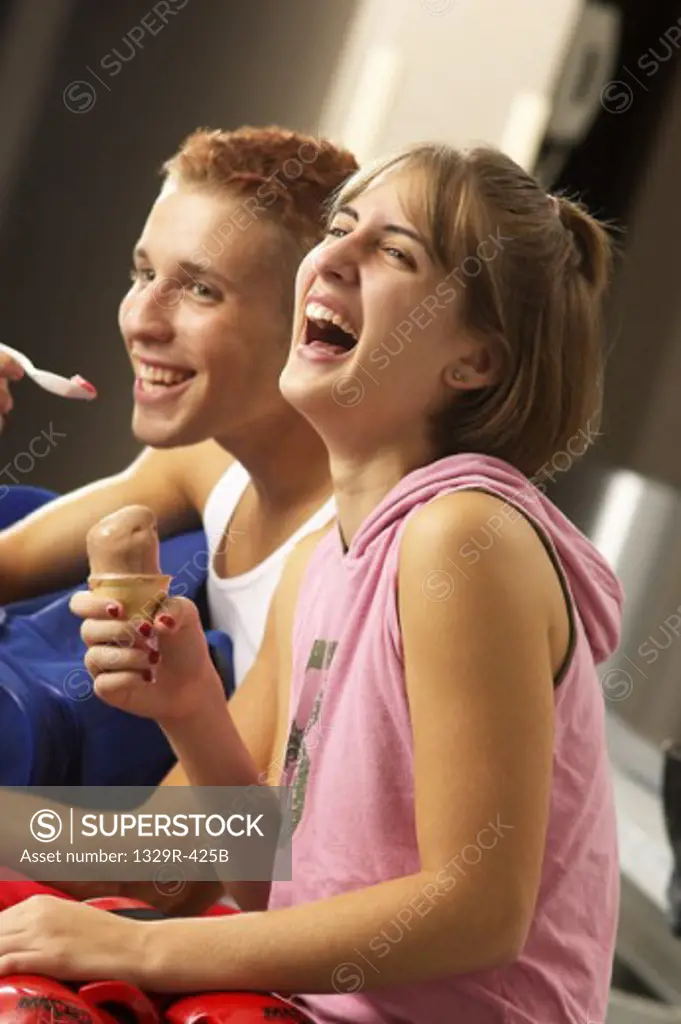 Side profile of a teenage couple laughing