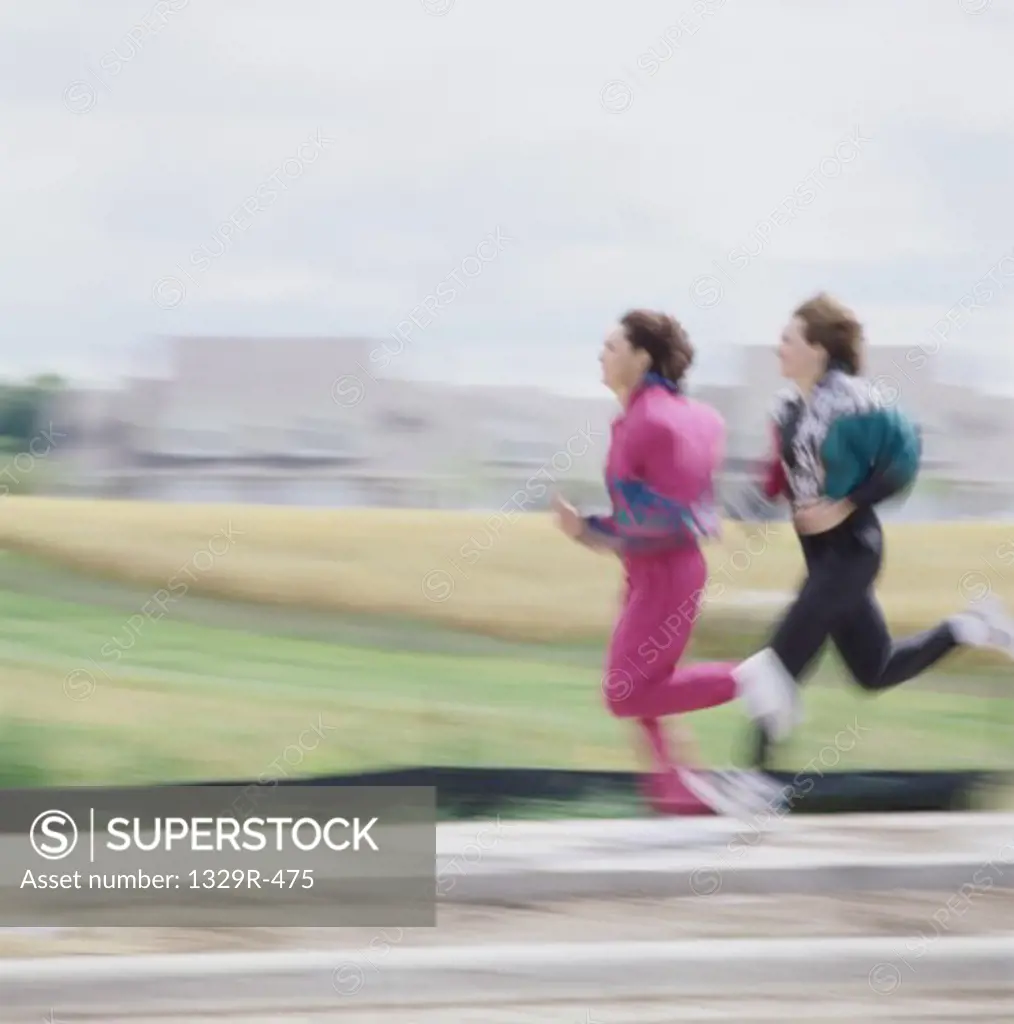 Two young women running