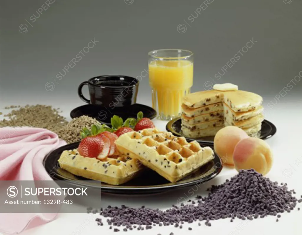 Plate of waffles and pancakes with a glass of orange juice