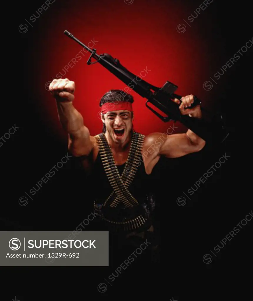 Portrait of a man holding a machine gun