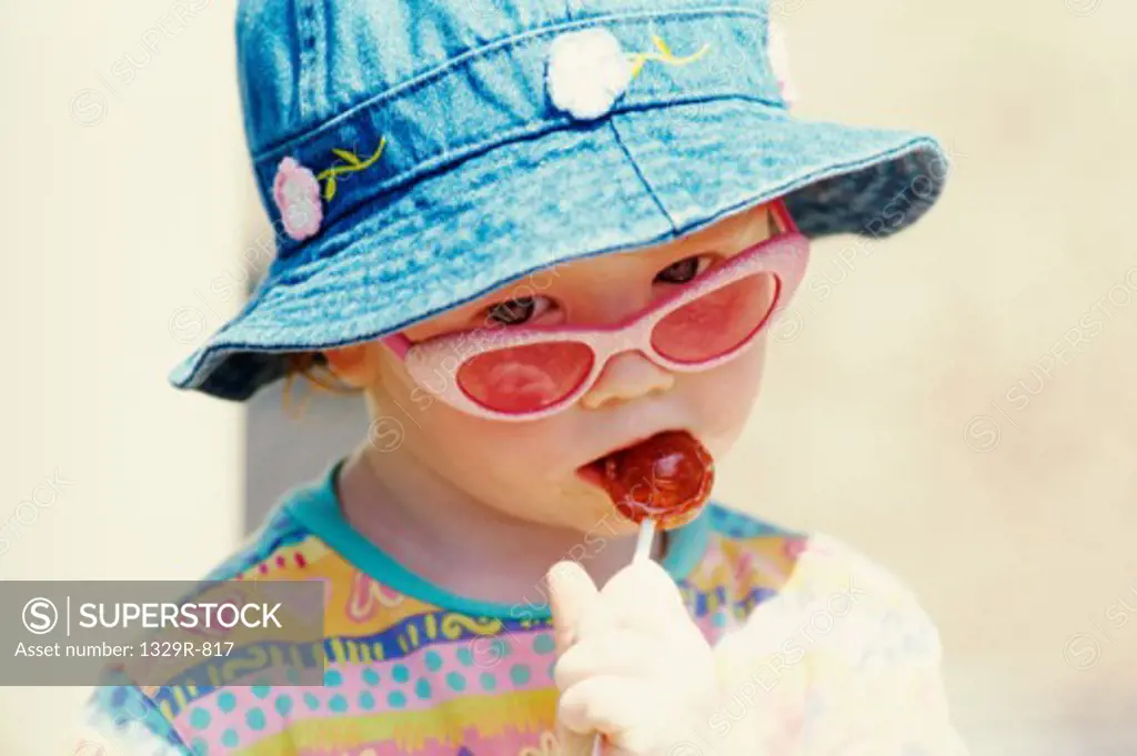 Close-up of a girl eating a lollipop