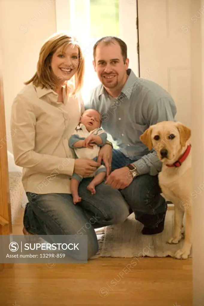 Portrait of parents with their son and a dog
