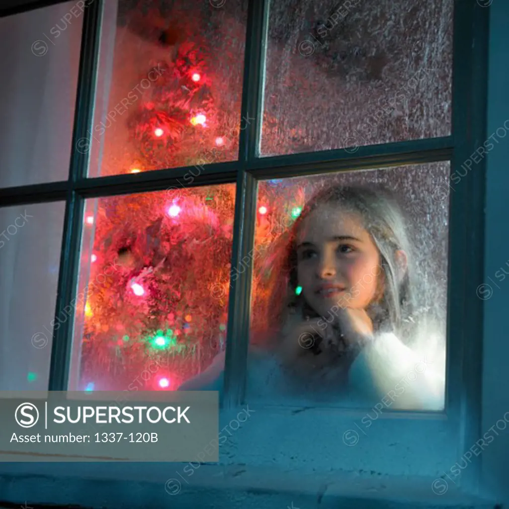 Girl looking out frosted window