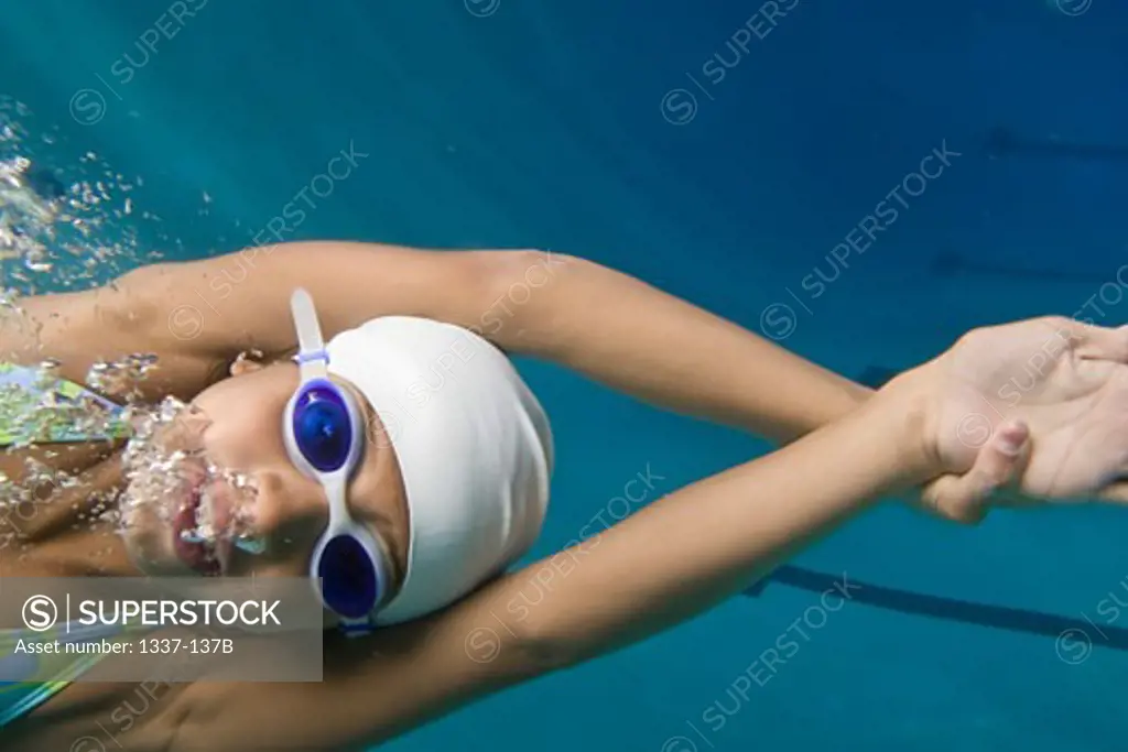 Close-up of a girl swimming in a swimming pool