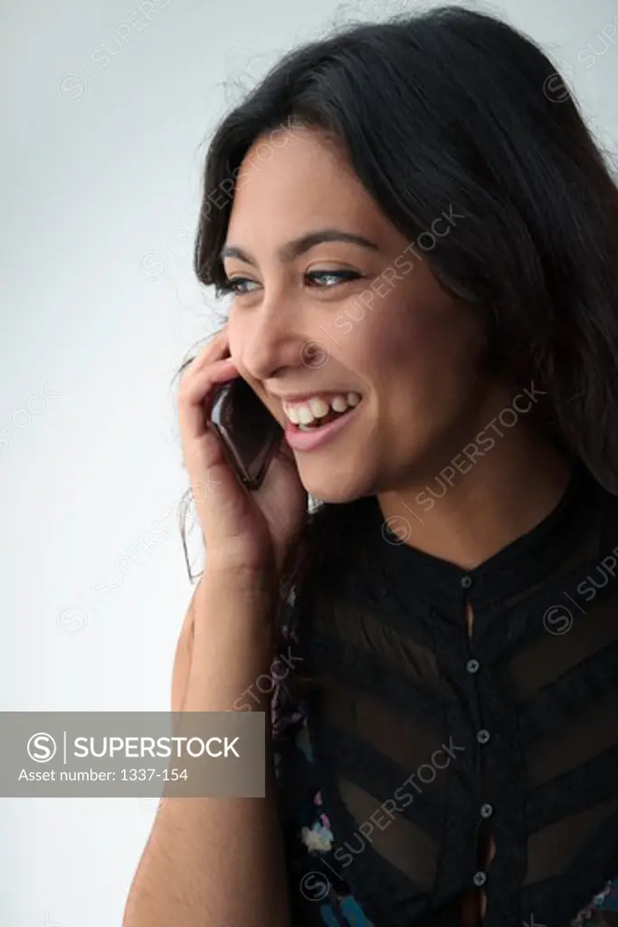 Studio Portrait of Mid Adult Woman Talking on Phone