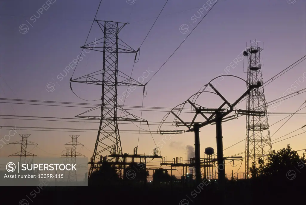 Silhouette of electric power pylons at a power station