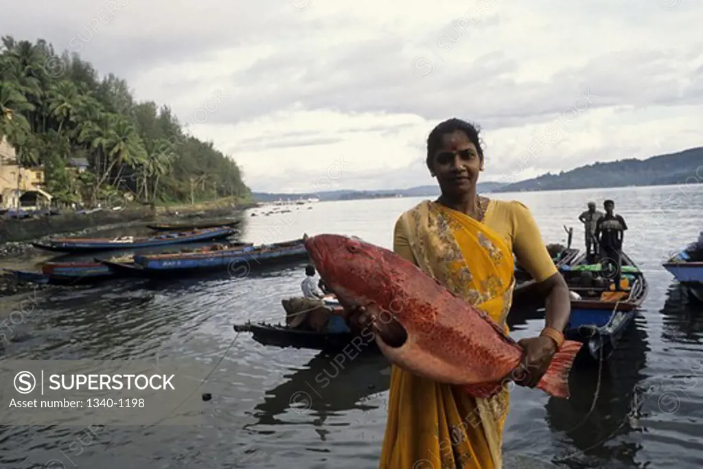 Fisherwoman holding a fish, Junglighat, Port Blair, Andaman and Nicobar Islands, India