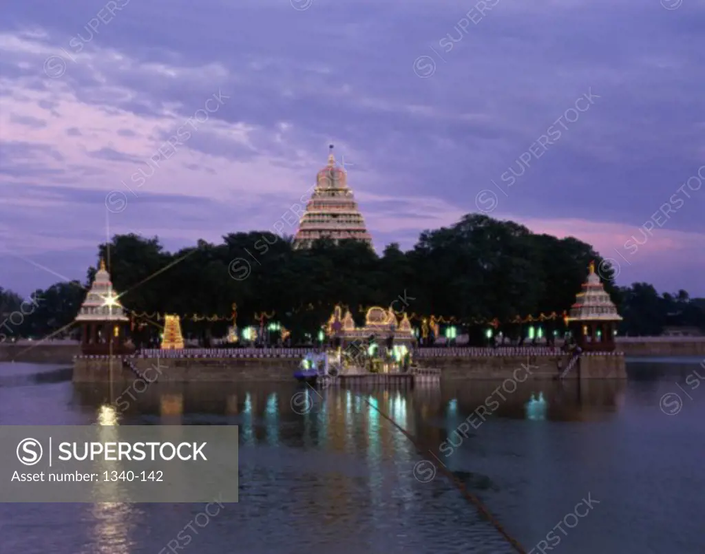 Temple on the waterfront lit up at dusk, Float Festival, Madurai, Tamil Nadu, India