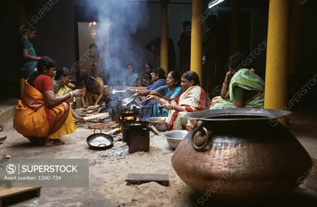 Women frying oil cakes, Chettinad, Tamil Nadu, India