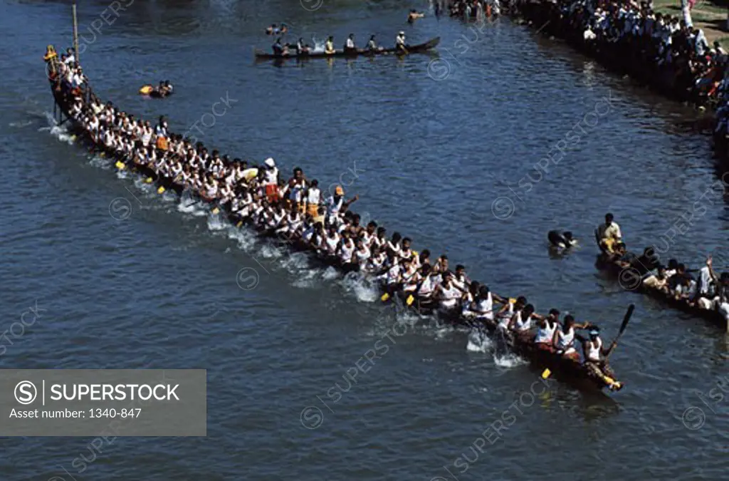 High angle view of a group of people participating in a traditional snake boat racing, Payippad Boat Race, Payippad Lake, Kerala, India
