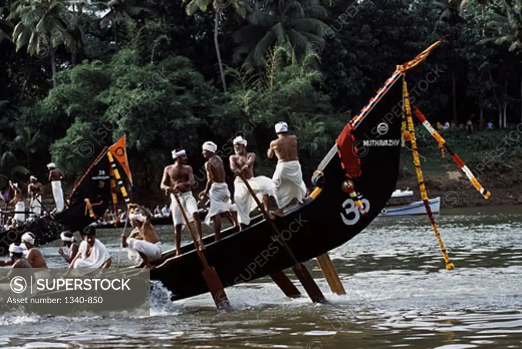 Group of people participating in a traditional snake boat racing, Aranmula Boat Race, Aranmula, Kerala, India