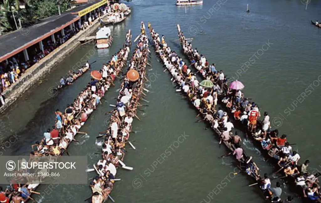 Group of people participating in a traditional snake boat racing, Payippad Boat Race, Payippad Lake, Kerala, India
