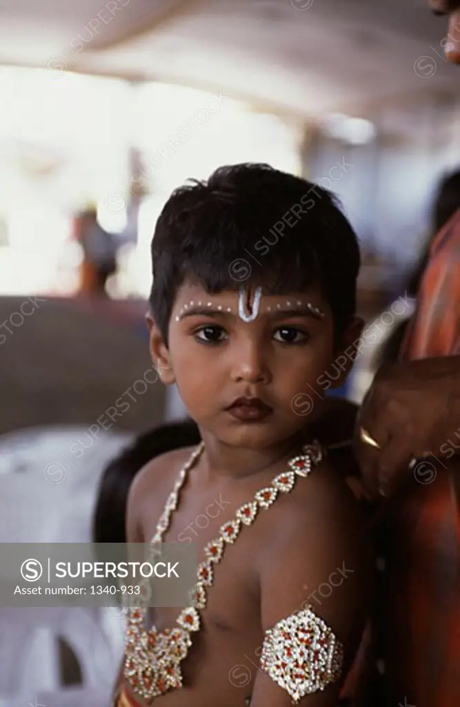 Close-up of a boy dressed as Lord Krishna in a religious festival of Krishna Janmashtami, Tamil Nadu, India