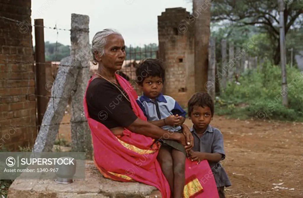 Side profile of a mature woman with her two grandsons, Tamil Nadu, India