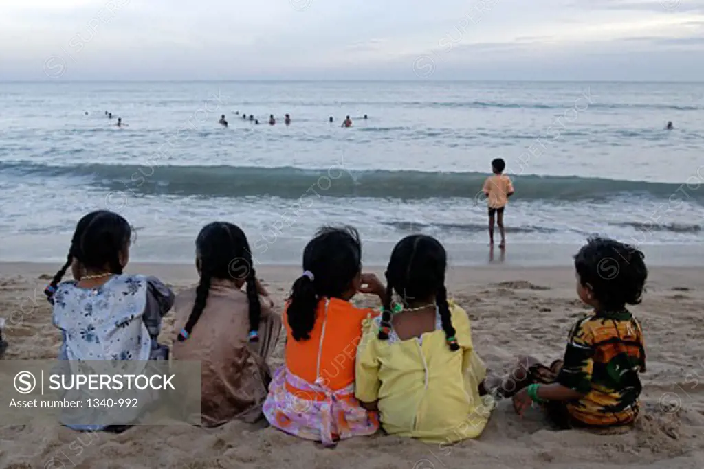 Five girls sitting on the beach, Kulasekarapattinam, Thoothukudi, Tamil Nadu, India