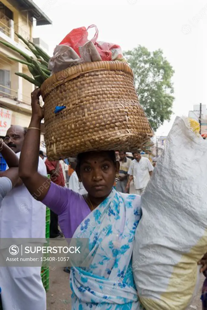 Woman carrying vegetables on her head, Madurai, Tamil Nadu, India