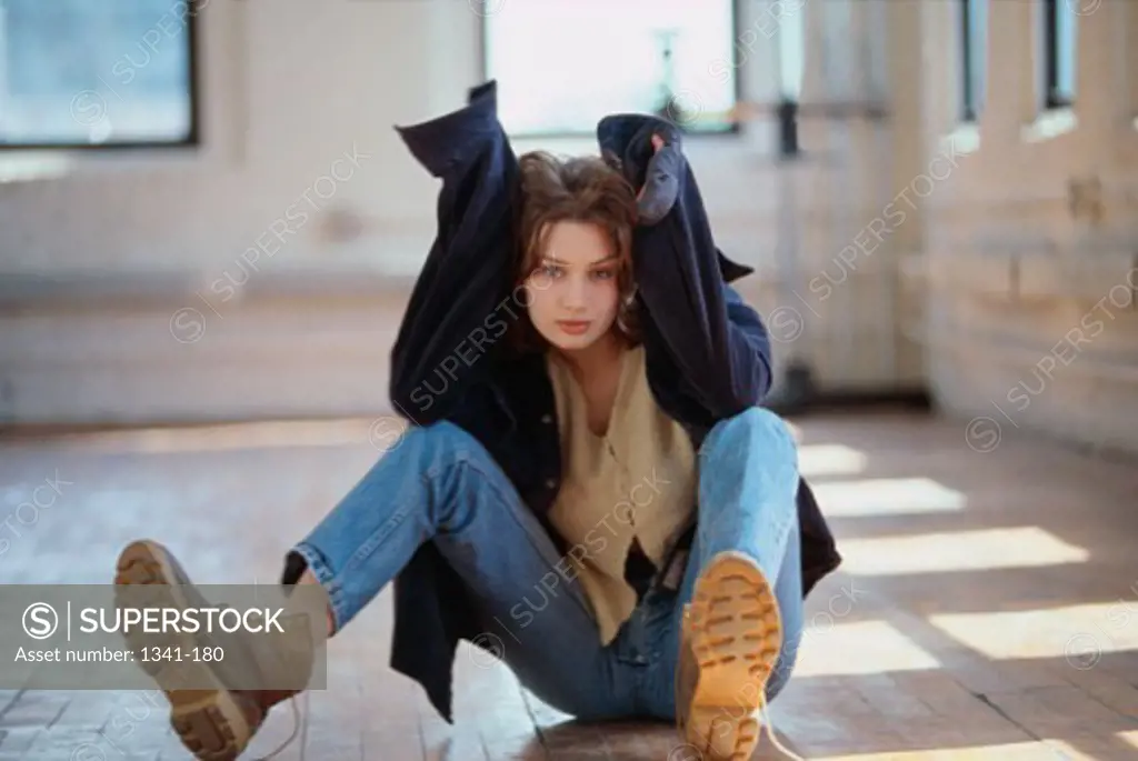 Portrait of a teenage girl sitting on the ground