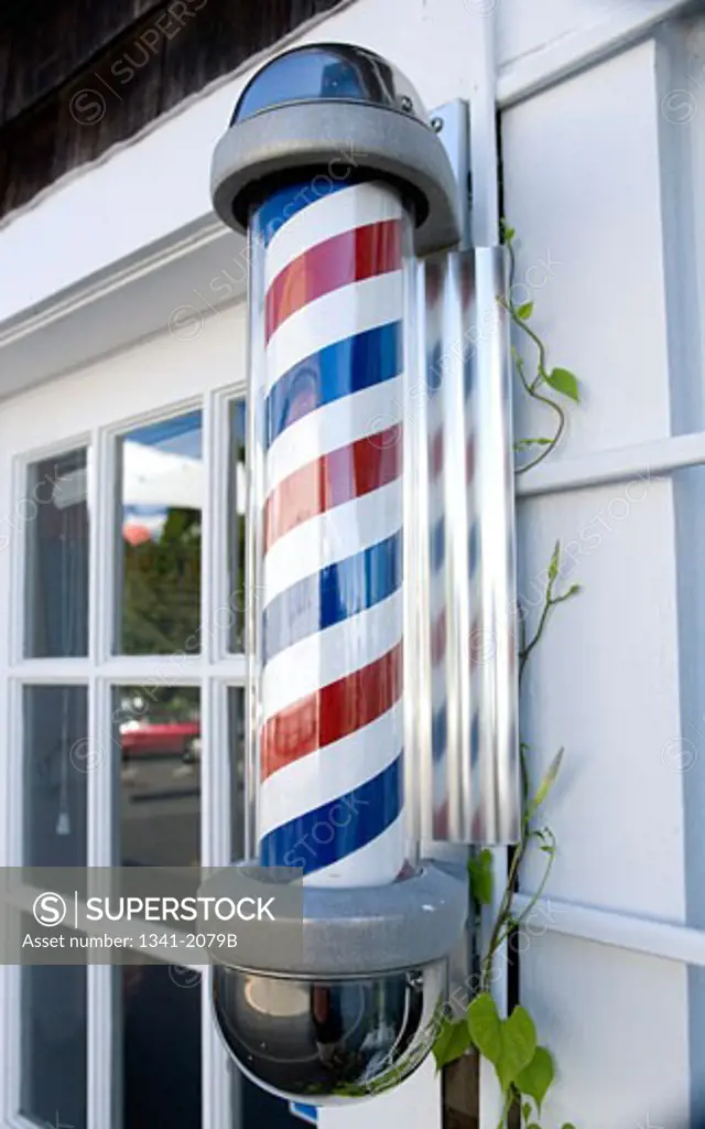 Barber pole mounted on the wall of a barber shop