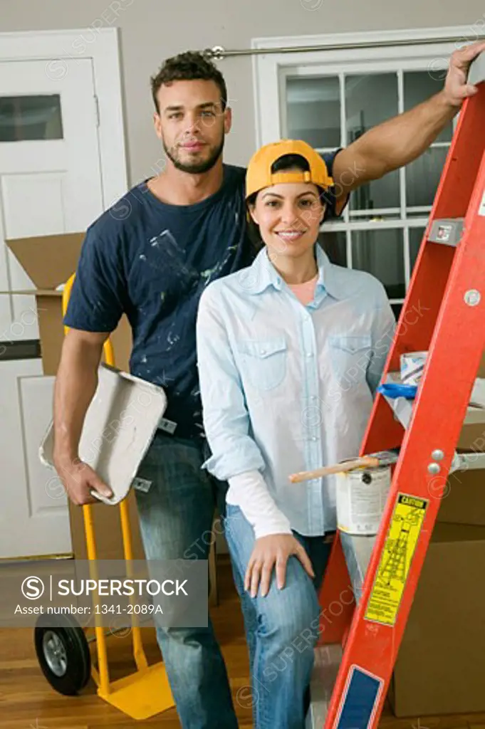 Young couple standing next to a ladder