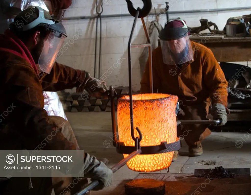 Men working with molten bronze