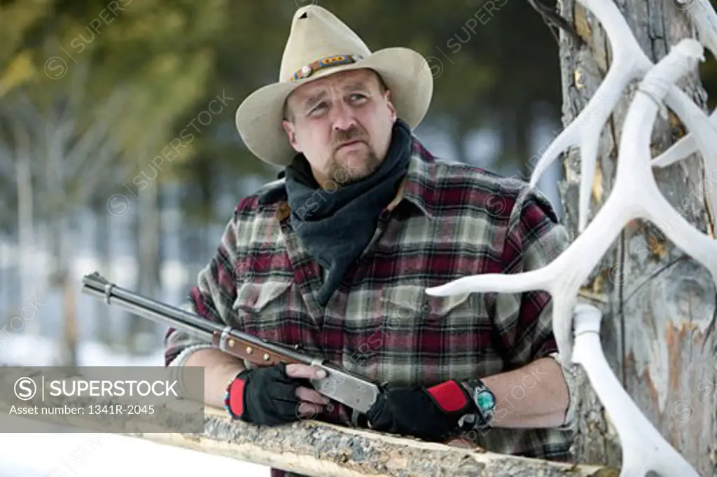 Close-up of a mature man holding a rifle, Jackson, Wyoming, USA