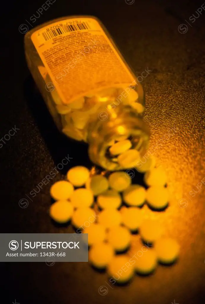 Close-up of tablets spilt out of a bottle