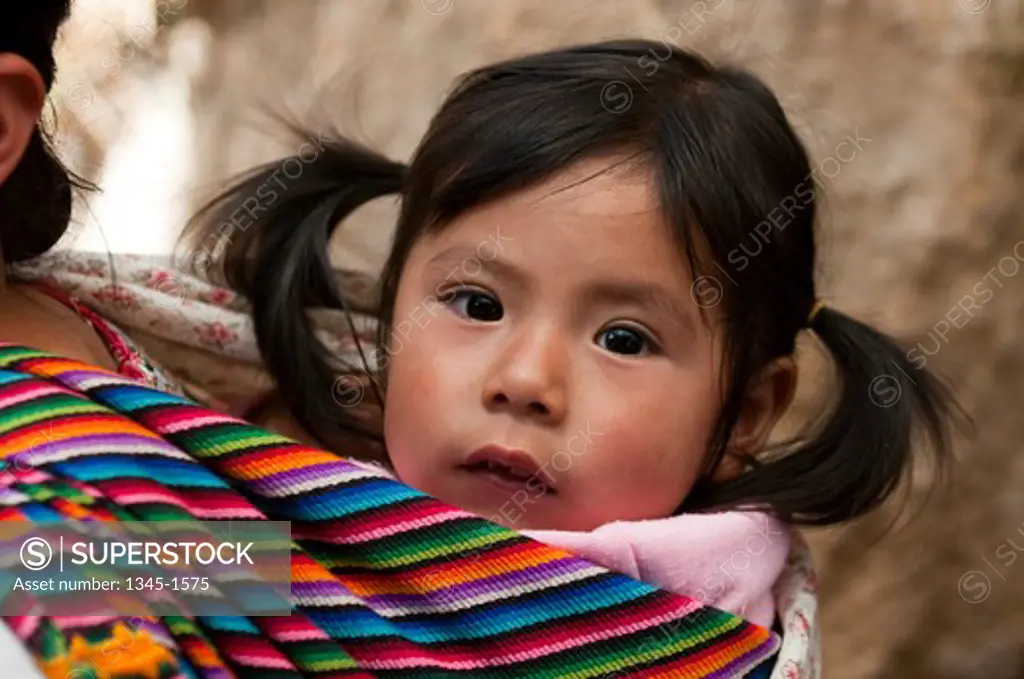 Woman carrying her daughter, San Francisco El Alto, Guatemala