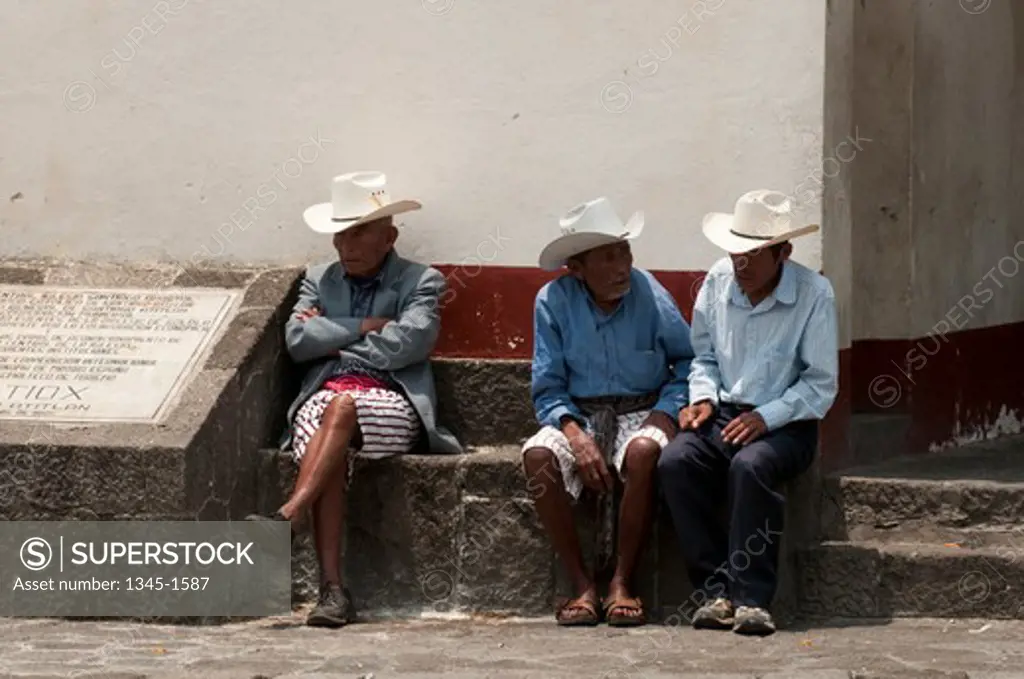 Three senior men sitting together, Santiago Atitlan, Lake Atitlan, Guatemala
